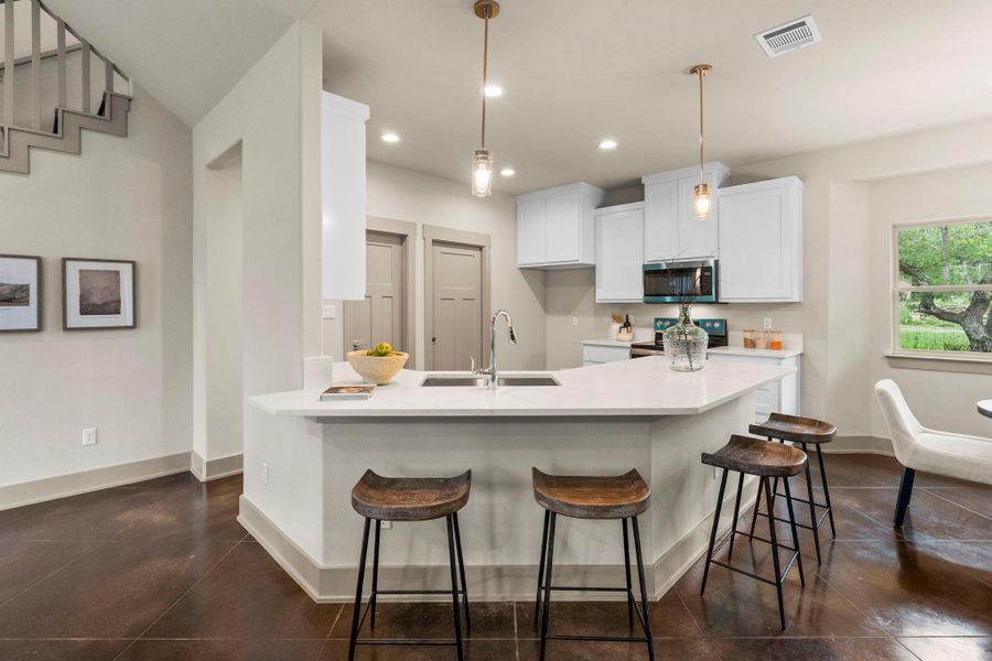 Open-concept kitchen featuring an eat-at island