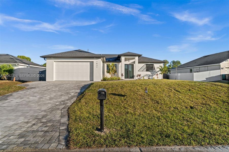 Front exterior of a new home in , Cape Coral, FL, highlighting curb appeal (Image 1). Front exterior of a new home in , Cape Coral, FL, highlighting curb appeal (Image 1).
