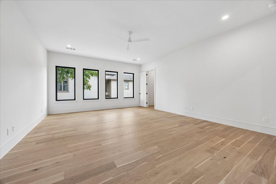 Designed as a true second living area, this spacious game room offers endless flexibility for entertaining, relaxing, or creating the perfect media lounge. Natural light pours through oversized windows, giving the room an open, inviting feel.