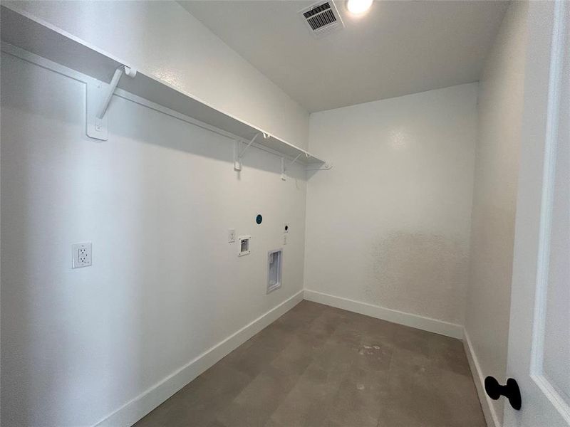 Laundry room spacious for extra storage or fridge.