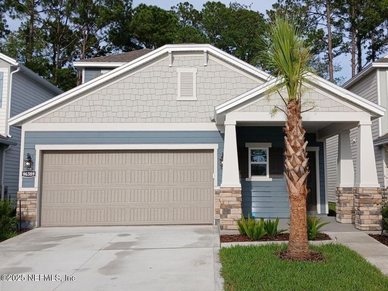 Front exterior of a new home in The Preserve at Concourse Crossing, Fernandina Beach, FL, highlighting curb appeal (Image 1).