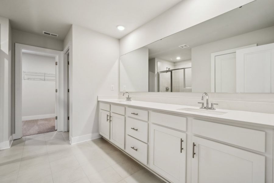 A bathroom with white cabinets. A bathroom with white cabinets.