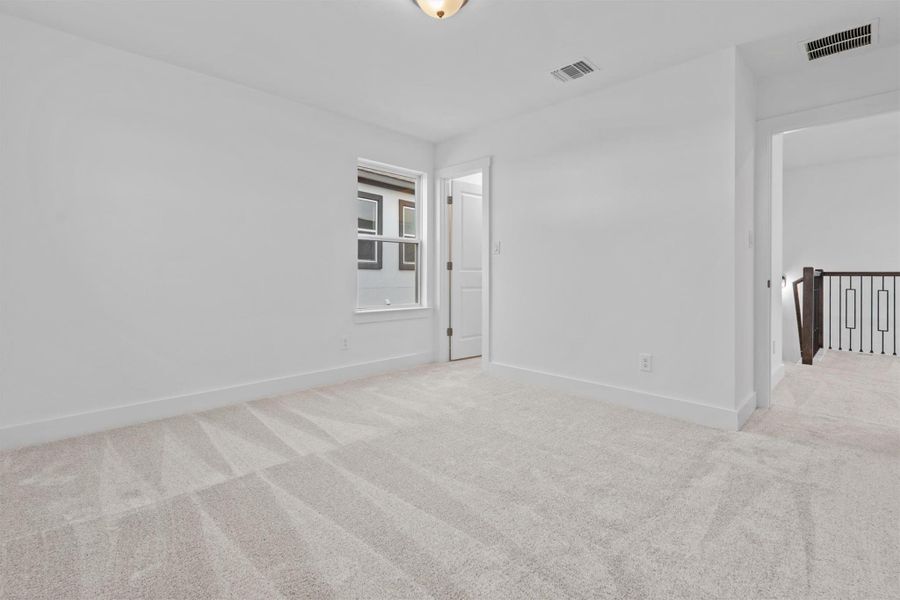 Unfurnished room featuring light colored carpet