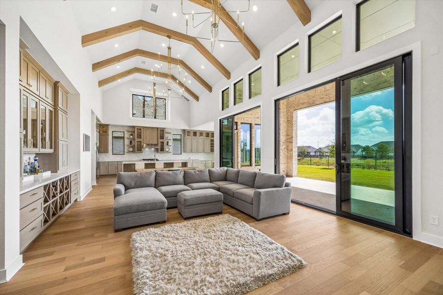 THE FAMILY ROOM OFFERS EXPANSIVE WINDOWS, SLIDING GLASS DOORS, AND WIDE-PLANK WOOD FLOORING. FROM THIS ANGLE, THE OPEN LAYOUT AND CONNECTION TO THE KITCHEN AND OUTDOOR LIVING SPACE ARE ON FULL DISPLAY. THE FAMILY ROOM OFFERS EXPANSIVE WINDOWS, SLIDING GLASS DOORS, AND WIDE-PLANK WOOD FLOORING. FROM THIS ANGLE, THE OPEN LAYOUT AND CONNECTION TO THE KITCHEN AND OUTDOOR LIVING SPACE ARE ON FULL DISPLAY.