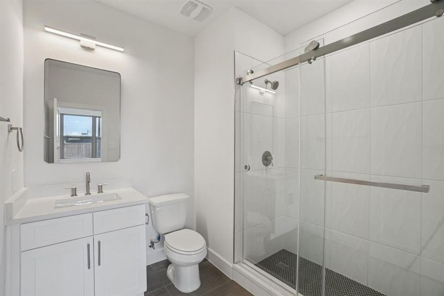 Full bathroom featuring a shower stall and vanity