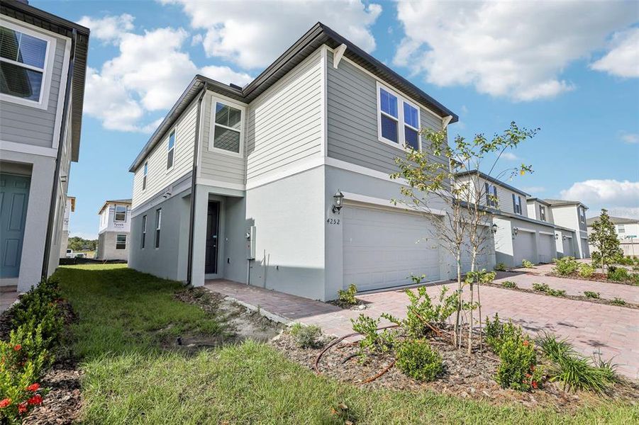 Exterior details and patio area of a home in The Meadow at Crossprairie Townes, St. Cloud (Image 26).