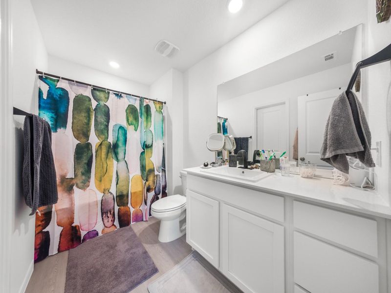 Full bath featuring a shower with curtain, vanity, light wood finished floors, and recessed lighting