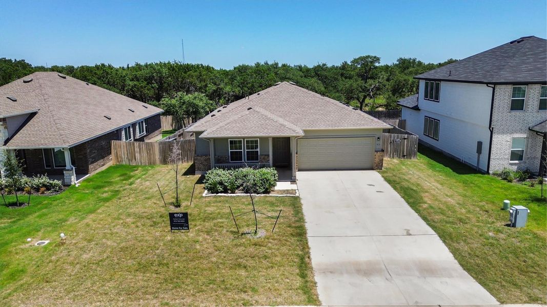 A well-maintained lawn and extended driveway enhance the curb appeal of this charming home.