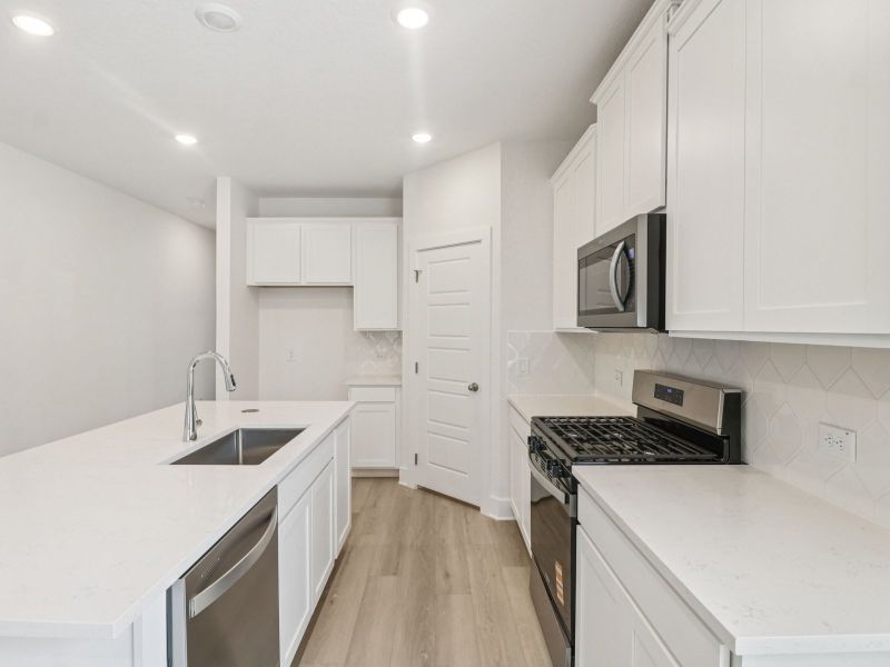 Kitchen in the Matador floorplan at a Meritage Homes community. Kitchen in the Matador floorplan at a Meritage Homes community.