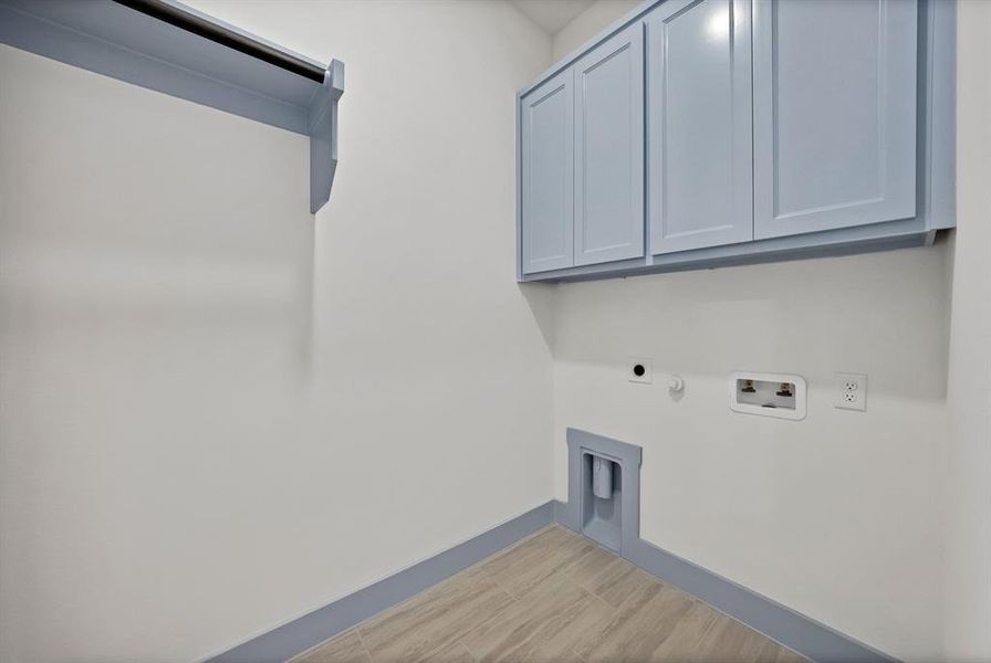 Washroom featuring gas dryer hookup, cabinet space, electric dryer hookup, and washer hookup