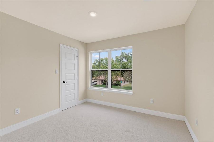 Neutral tone walls with white trim and light carpet flooring