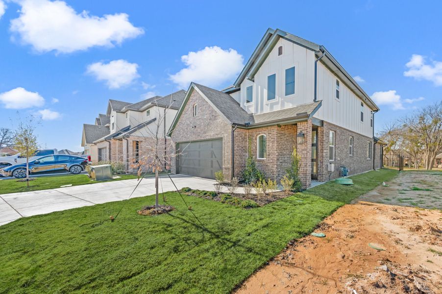 Front exterior of a new home in The Resort on Eagle Mt. Lake, Fort Worth, TX, highlighting curb appeal (Image 28). Front exterior of a new home in The Resort on Eagle Mt. Lake, Fort Worth, TX, highlighting curb appeal (Image 28).