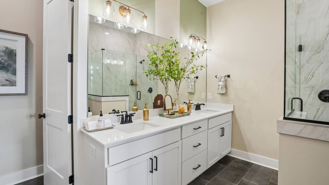 Primary bathroom with dual vanity and glass enclosed shower Primary bathroom with dual vanity and glass enclosed shower