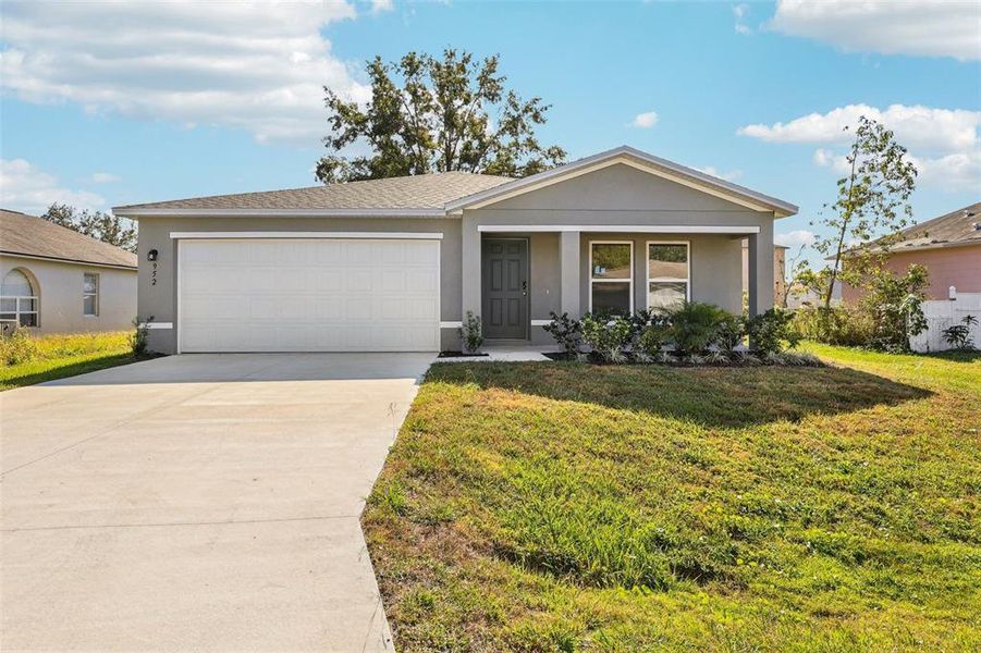 Front exterior of a new home in Stone Ridge, Sebring, FL, highlighting curb appeal (Image 8).