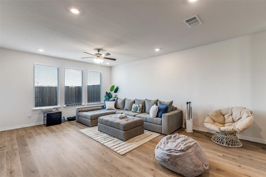 Living area with light wood finished floors, recessed lighting, and ceiling fan Living area with light wood finished floors, recessed lighting, and ceiling fan