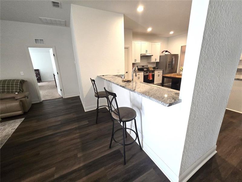 Living room open to kitchen with breakfast bar
