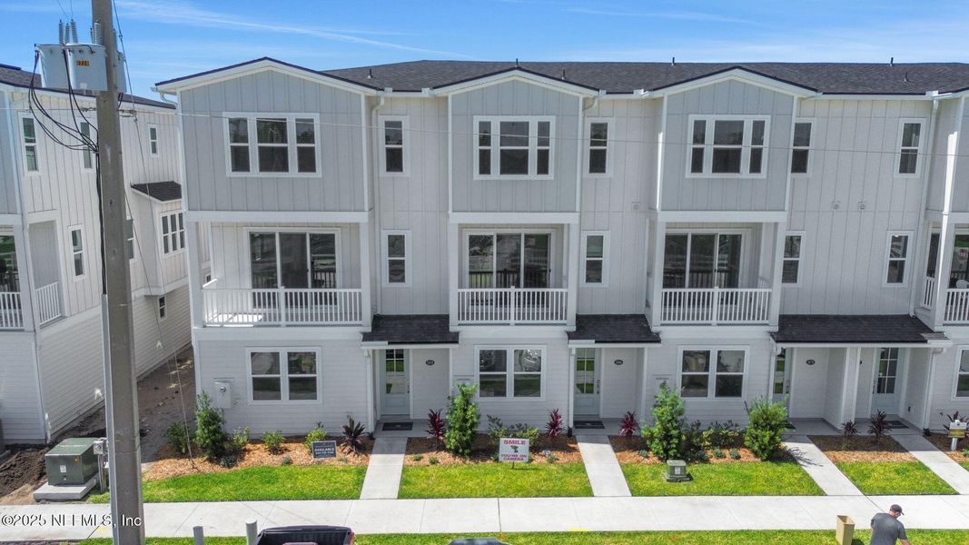 Front exterior of a new home in North Beach Townhomes, Jacksonville Beach, FL, highlighting curb appeal (Image 17).