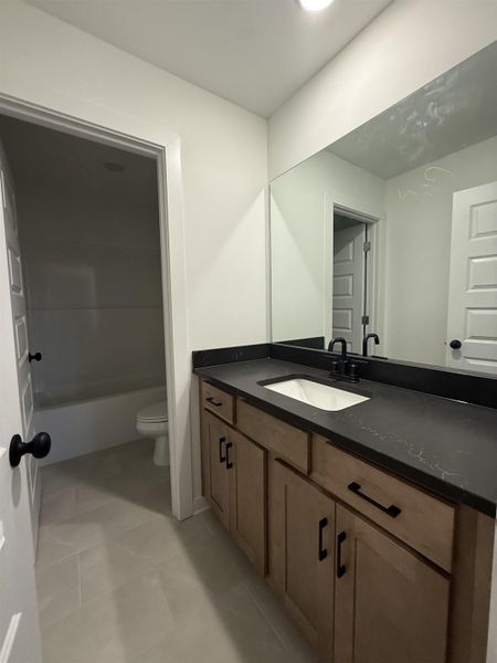 Bathroom featuring vanity, light tile patterned floors, and shower / bath combination