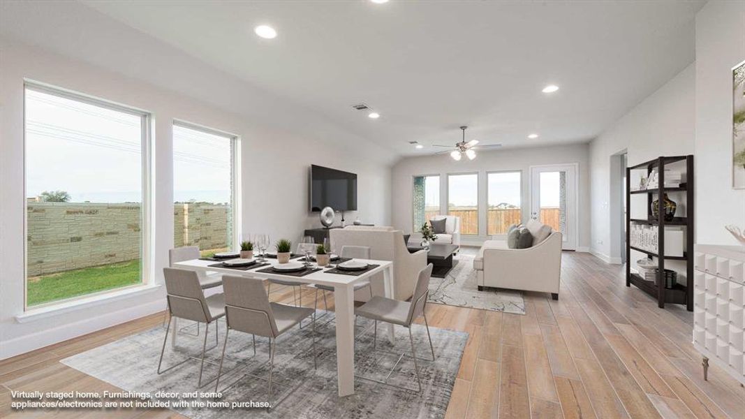 Dining area featuring ceiling fan and light wood-type flooring