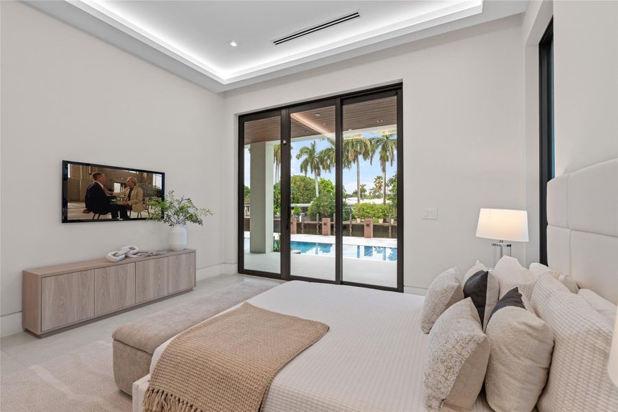 Guest bedroom with poolside views, direct outdoor access, and modern design with floor-to-ceiling windows. Guest bedroom with poolside views, direct outdoor access, and modern design with floor-to-ceiling windows.