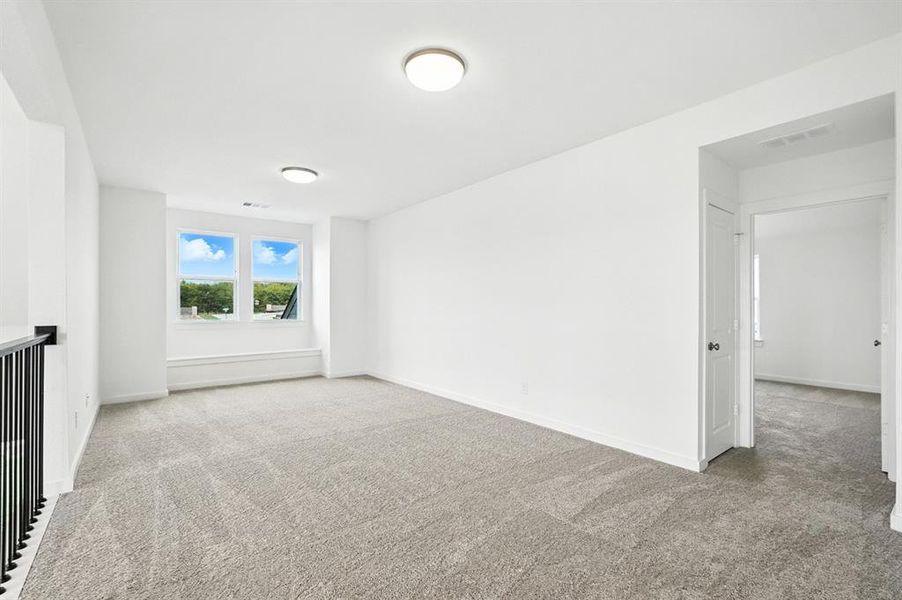 Unfurnished room featuring light colored carpet and baseboards Unfurnished room featuring light colored carpet and baseboards