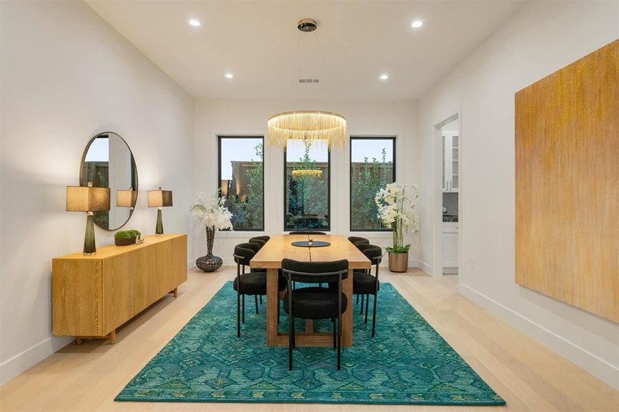 Dining area with recessed lighting and light wood-type flooring Dining area with recessed lighting and light wood-type flooring