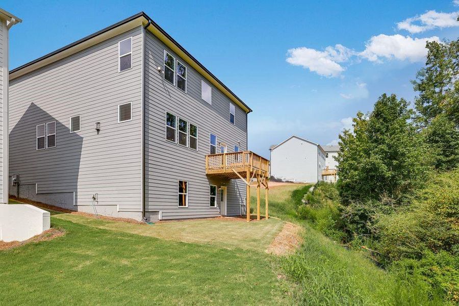 Front exterior of a new home in Falls Creek, Flowery Branch, GA, highlighting curb appeal (Image 1).