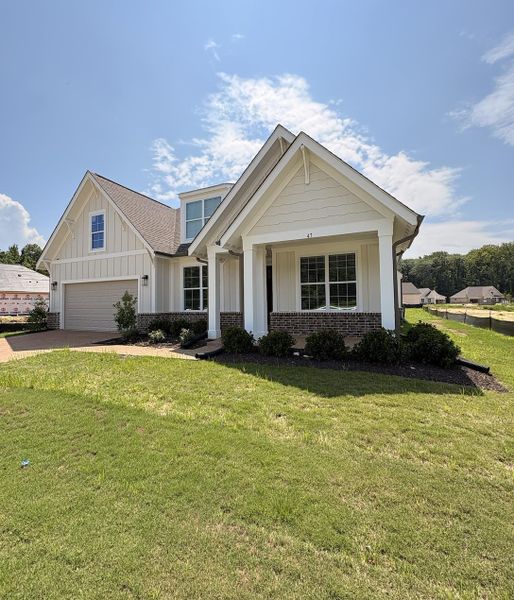 Light-toned exterior with mixed siding and brick accents Light-toned exterior with mixed siding and brick accents
