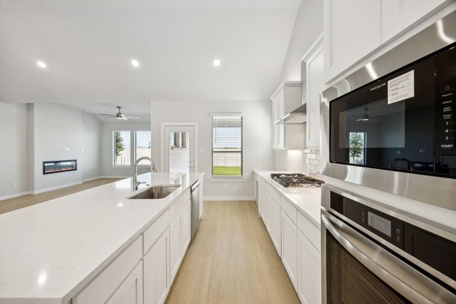 Kitchen in the Wimbledon home plan by Trophy Signature Homes – REPRESENTATIVE PHOTO