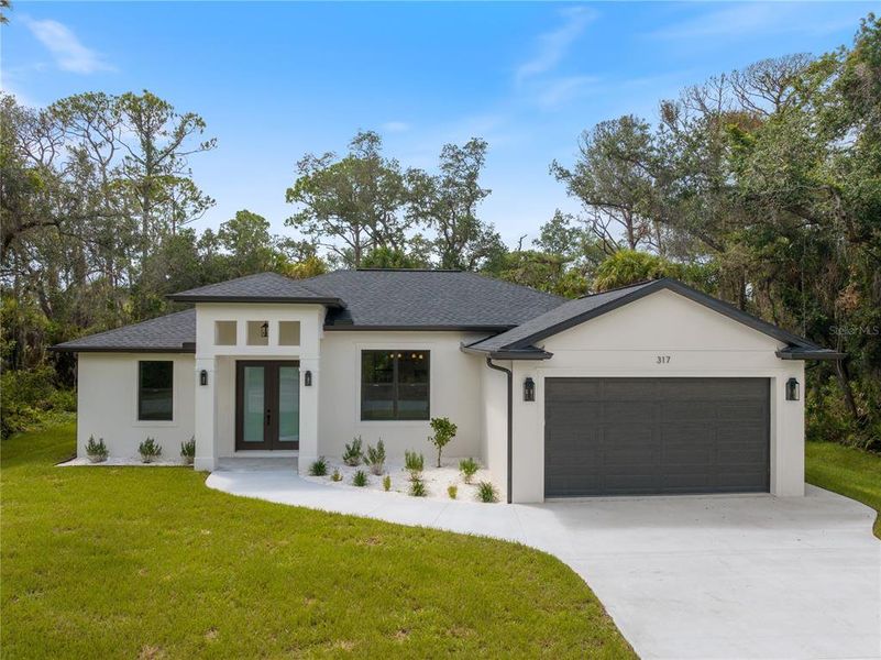 Front exterior of a new home in , Port Charlotte, FL, highlighting curb appeal (Image 17).