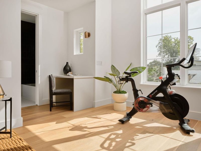 Exercise room with light wood-style floors and baseboards Exercise room with light wood-style floors and baseboards
