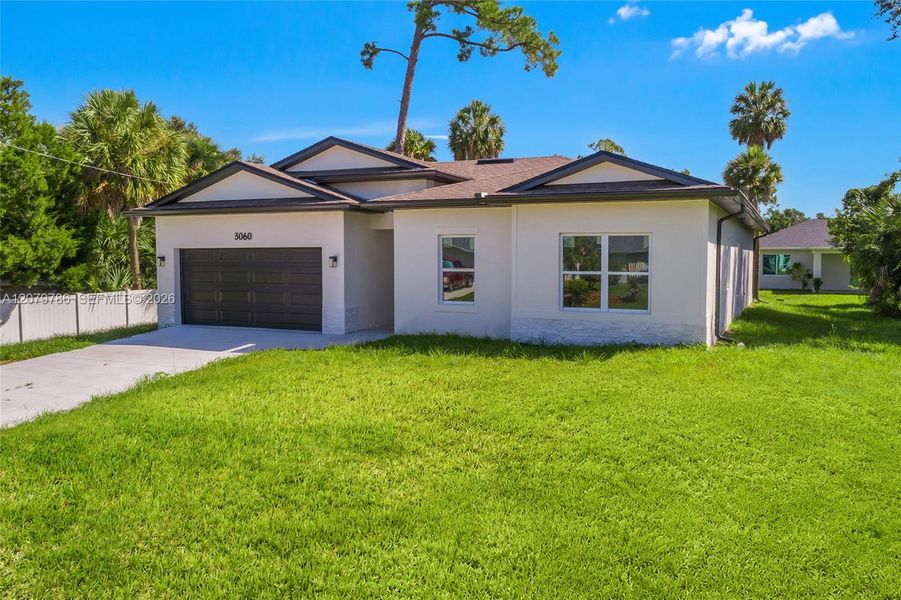 Front exterior of a new home in , North Port, FL, highlighting curb appeal (Image 17). Front exterior of a new home in , North Port, FL, highlighting curb appeal (Image 17).