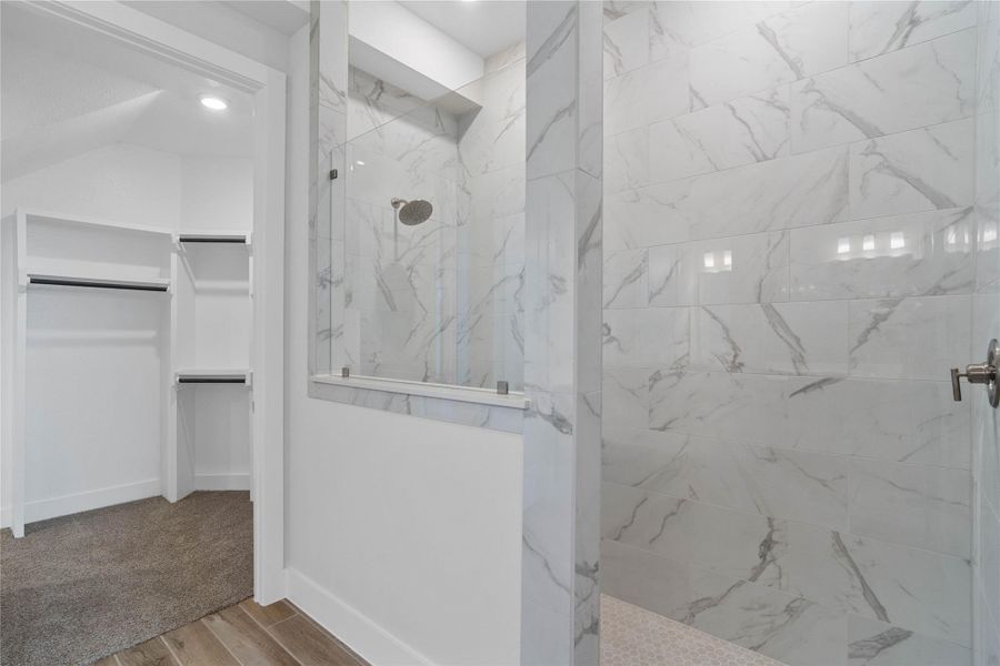 This thoughtfully designed primary suite offers exceptional flow and functionality, providing a seamless and luxurious transition from a spa-like walk-in shower to a spacious walk-in closet. This thoughtfully designed primary suite offers exceptional flow and functionality, providing a seamless and luxurious transition from a spa-like walk-in shower to a spacious walk-in closet.