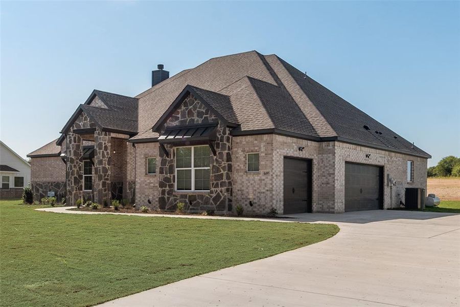 View of front of house with a front lawn and cooling unit