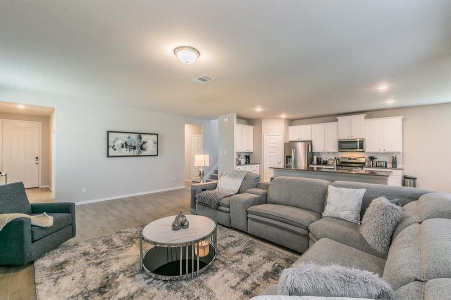 Living area with recessed lighting and wood finished floors
