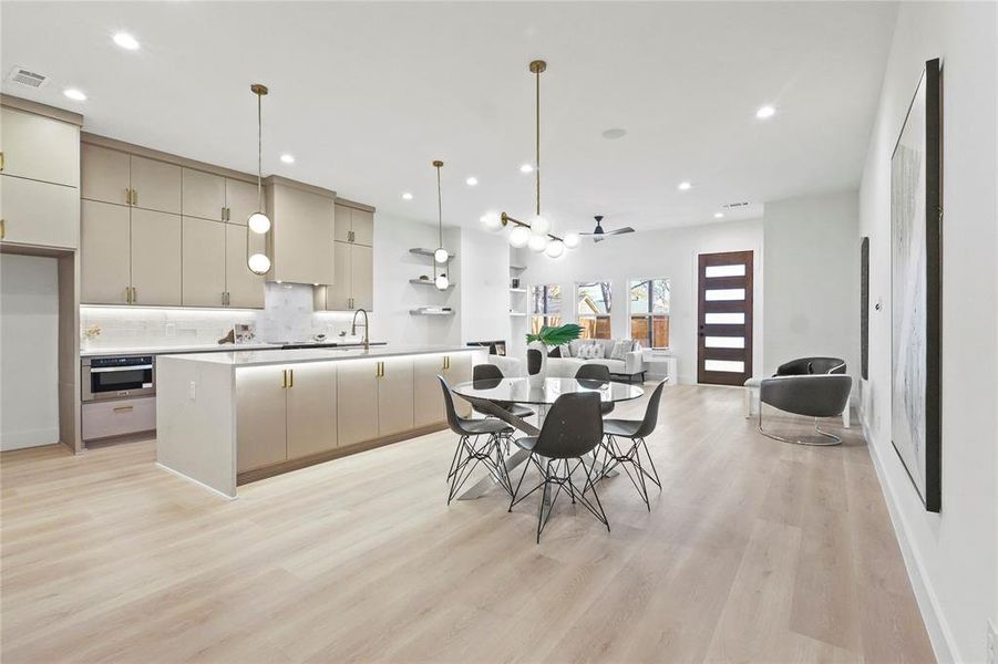 Dining area with light wood-type flooring, a ceiling fan, and recessed lighting