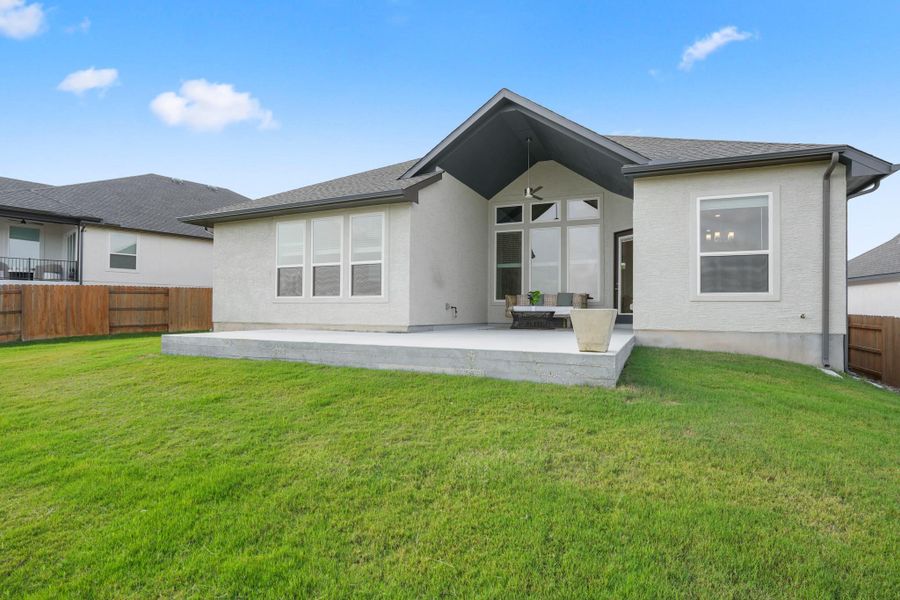 A spacious backyard with a generous patio offers ample room for outdoor activities.