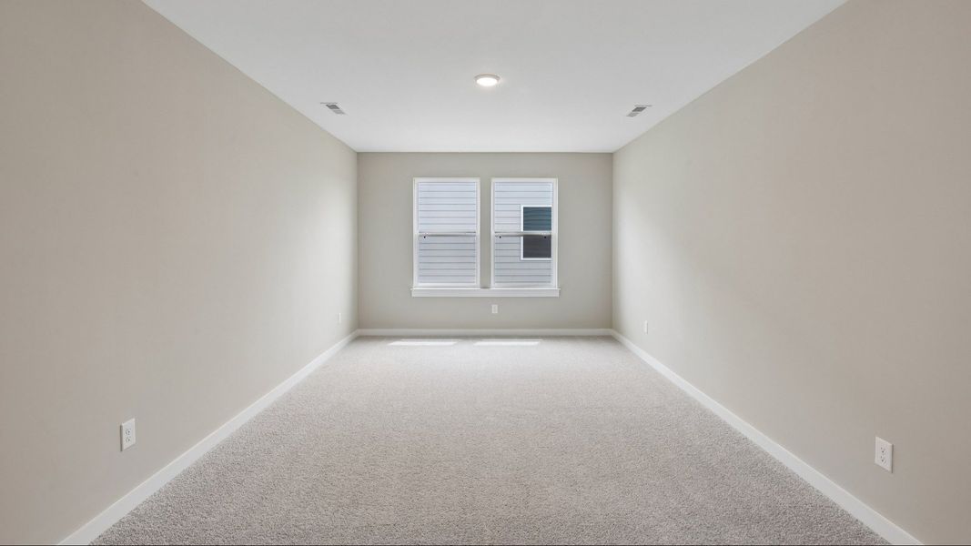 Second Floor Loft area with windows and carpet