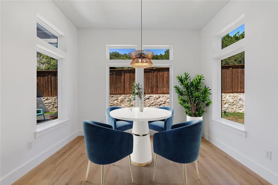 Dining room featuring a chandelier, plenty of natural light, and light hardwood / wood-style floors