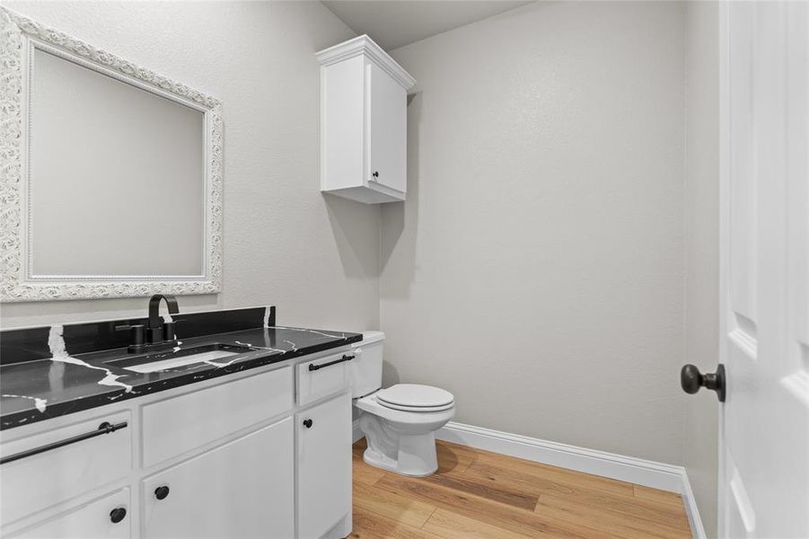 Bathroom with light wood-type flooring and vanity