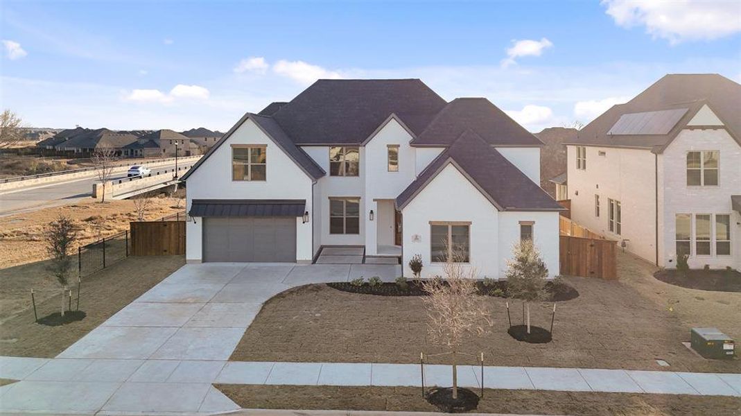 Front exterior of a new home in Light Farms Graham/Reagan, Celina, TX, highlighting curb appeal (Image 26).