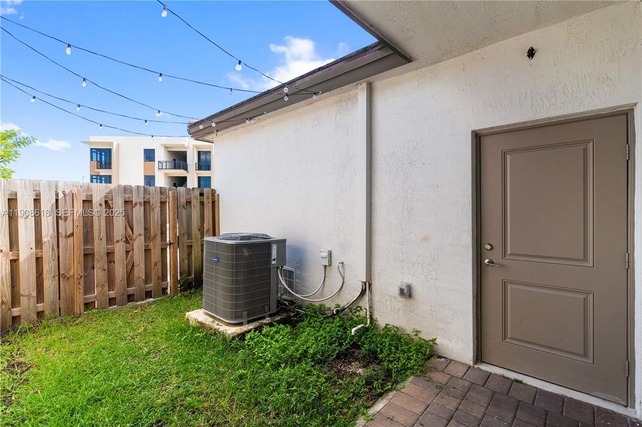 Exterior details and patio area of a home in Harmony Parc, Homestead (Image 23).