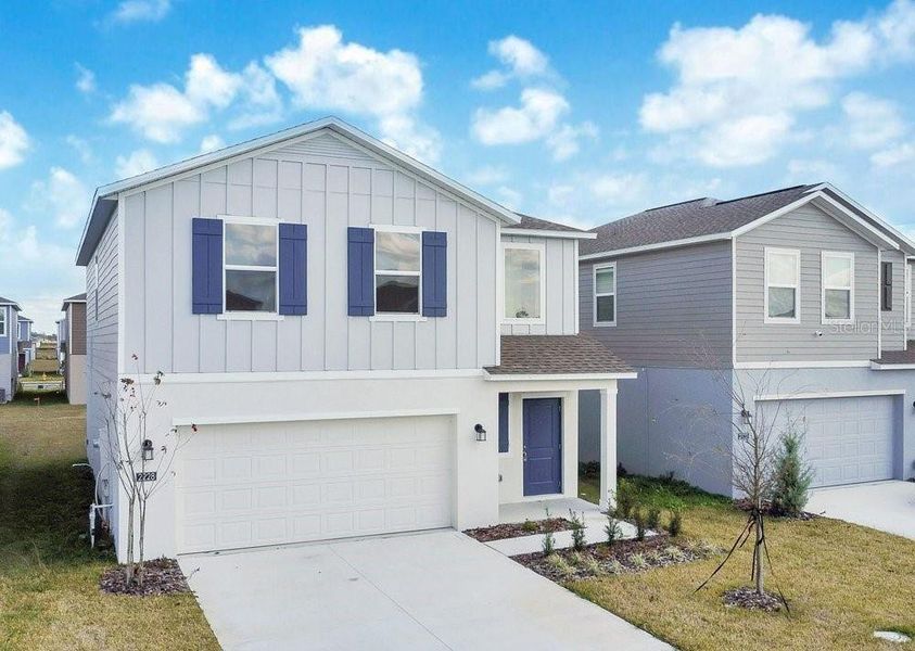 Front exterior of a new home in Peace Creek Reserve, Winter Haven, FL, highlighting curb appeal (Image 13).