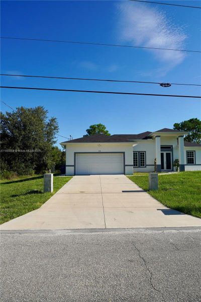 Front exterior of a new home in , Lehigh Acres, FL, highlighting curb appeal (Image 27).