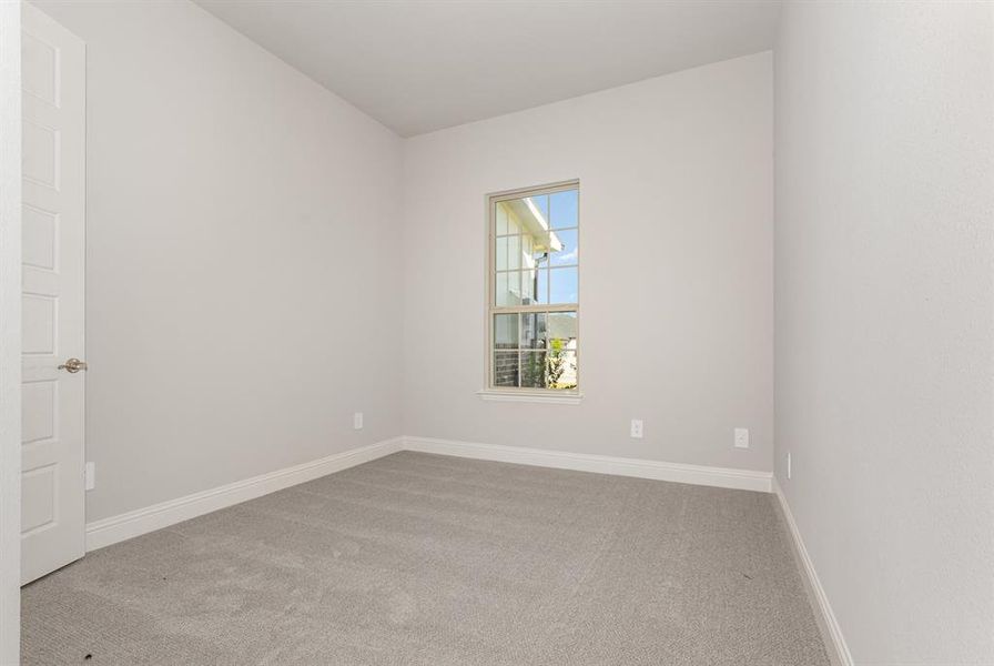 Unfurnished room featuring light colored carpet and baseboards