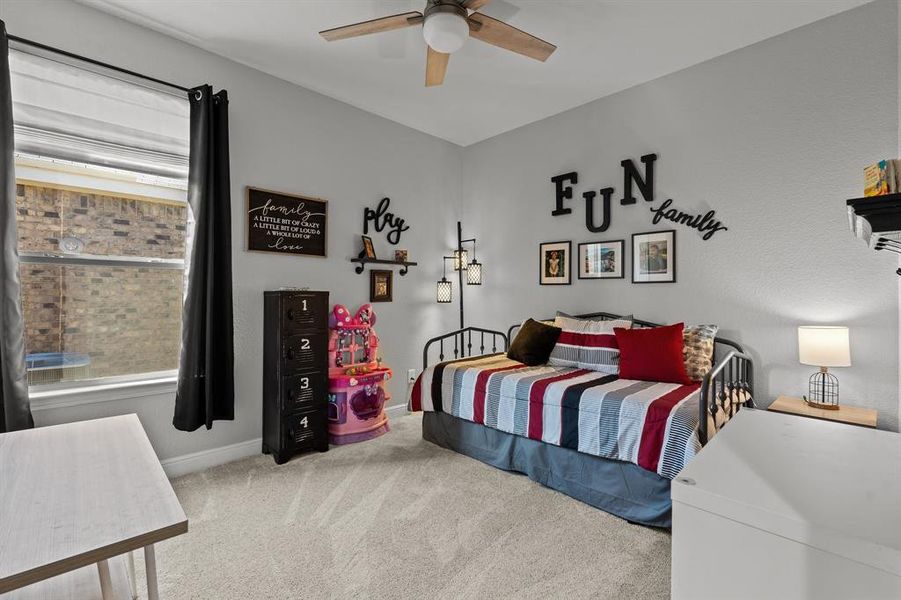 Carpeted bedroom with ceiling fan