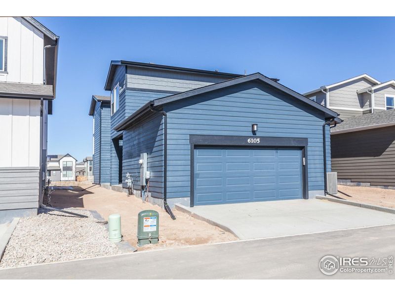 Front exterior of a new home in Trailside Alley Load - Single Family Homes, Timnath, CO, highlighting curb appeal (Image 23).