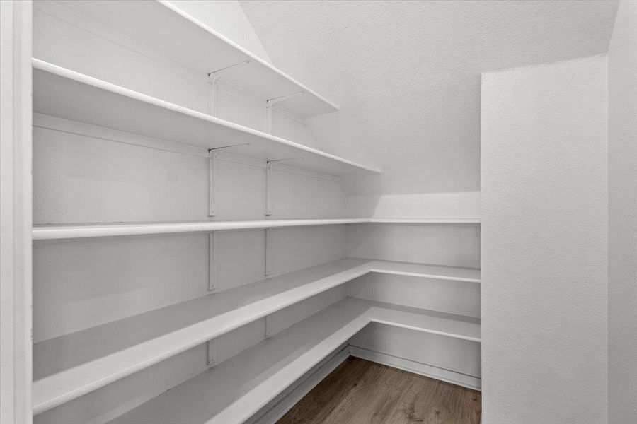 Ample built-in shelving provides generous storage in this well-appointed pantry.
