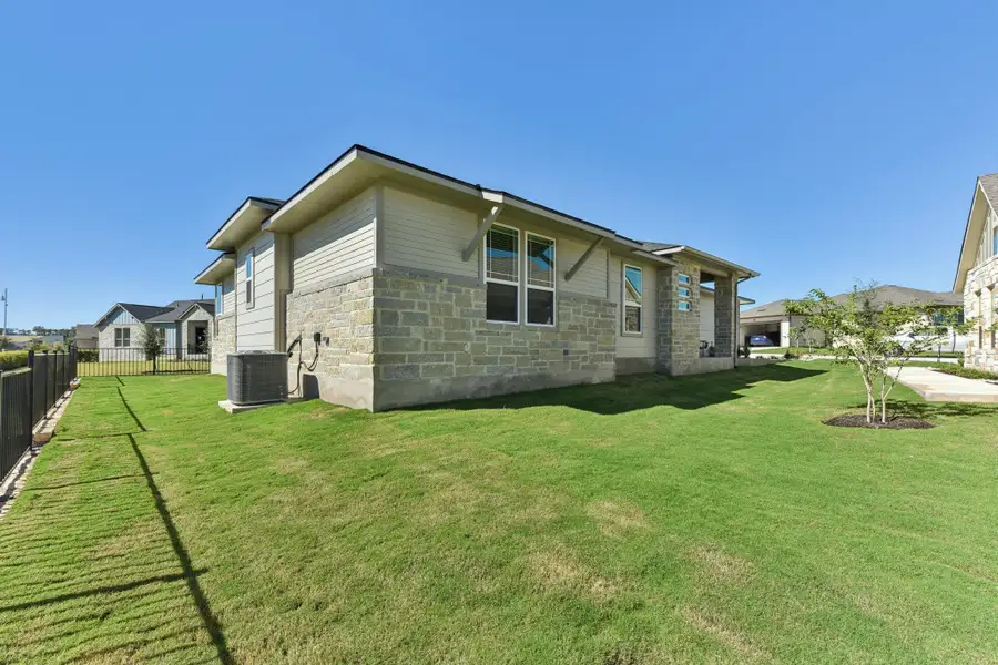 View of side of home featuring stone siding and a central air condition unit