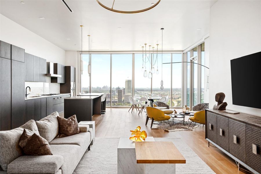 The living area is well-lit with a contemporary light fixture and panoramic views.